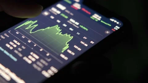 Analyzing stock chart on smart phone at night Stock Footage 162255787