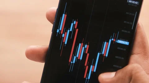 Analyzing stock chart on smart phone at night Stock Footage 168141779