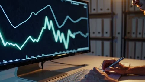 Analyzing stock market trends using data visualization techniques at an office d Stock Footage 297465251
