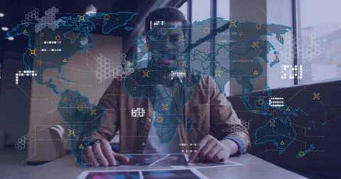 Analyzing tablet and prints, man wearing brown jacket studying global data Stock Photos