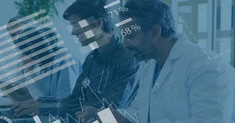 Analyzing team in lab coats, scrubs reviewing data overlays at desk with laptop Stock Photos