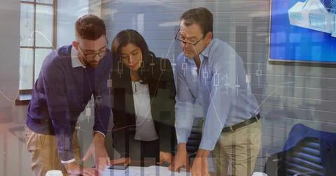Analyzing team reviewing printed reports and discussing data at conference Stock Photos
