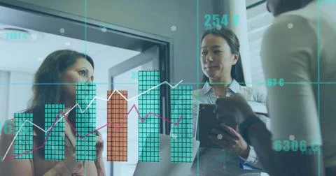 Analyzing three analysts in business attire presenting data on glass partition Stock Photos