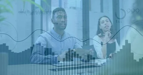 Analyzing three colleagues discussing data overlays at meeting table, with Stock Photos