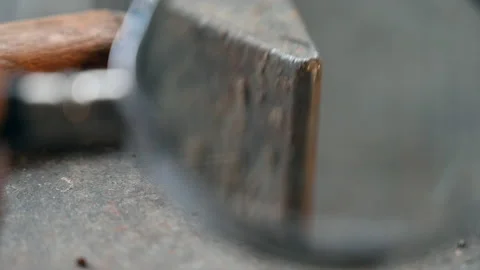Analyzing  the tip of a hammer with the magnifying lens Stock Footage 152906327