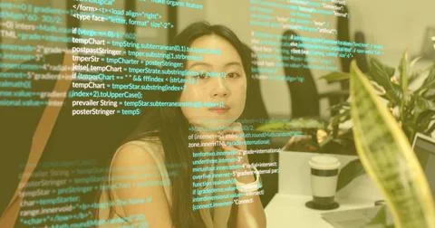 Analyzing transparent code display, Asian female sitting at office desk, with Stock Photos
