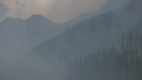 Anamorphic Atmospheric Forest Fire Smoke over Mountains Stock Footage 93064255