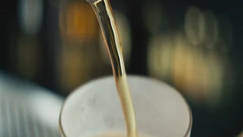 Anamorphic close up beer pouring from top Stock Footage 89998700