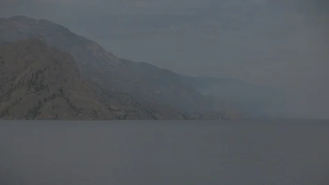 Anamorphic Forest Fire Smoke on Mountain Next to Lake Stock Footage 93064091