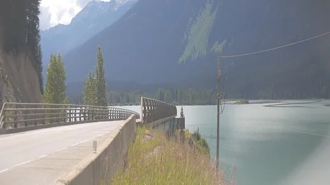 Anamorphic Highway in Mountains with Vibrant Colored River Stock Footage 93062964