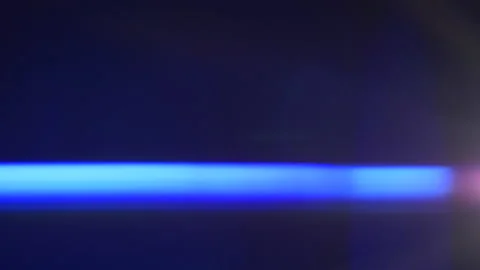 Anamorphic lens flare, bokeh light leaks, flash ray effect over black background Stock Footage 220697815