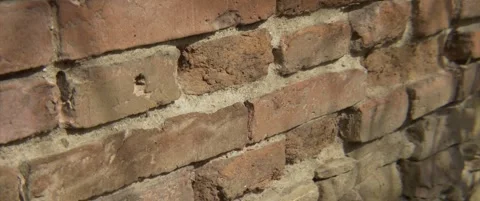 Anamorphic old bricked wall close-up 4K tilting video Stock Footage 304575865
