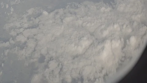 Anamorphic shot above clouds land earth planet clouds airplane wing window view  Stock Footage 118882277