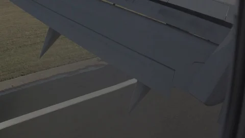 Anamorphic shot airplane window view aircraft landing Stock Footage 118858861