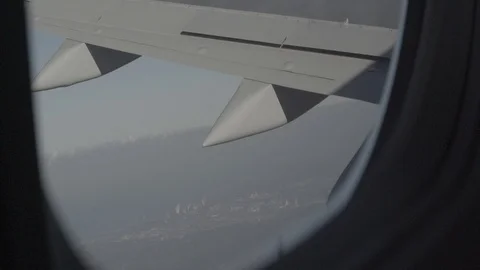 Anamorphic shot of airplane wing while aircraft changing altitude Stock Footage 118883406