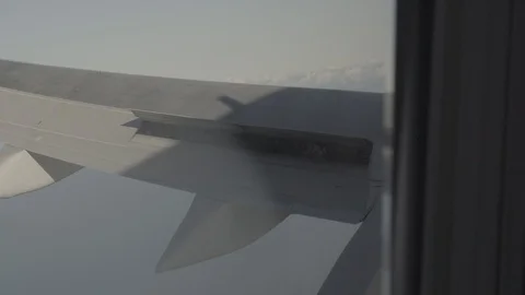 Anamorphic shot airplane wing window aircraft view sky and clouds Stock Footage 118858933