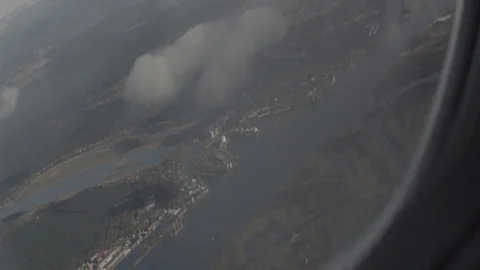 Anamorphic shot airplane wing window aircraft view sky lake river clouds Stock Footage 118858975