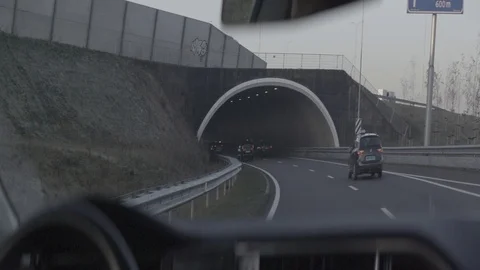 Anamorphic shot entering exiting driving in tunnel bridge Stock Footage 118885693