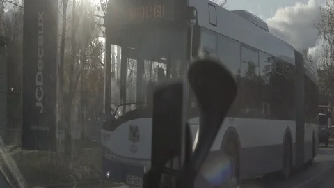 Anamorphic shot view from inside car of street road passing by bus cars trucks Stock Footage 118857954