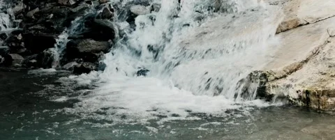 Anamorphic small mountain waterfall in blue river Stock Footage 328935444