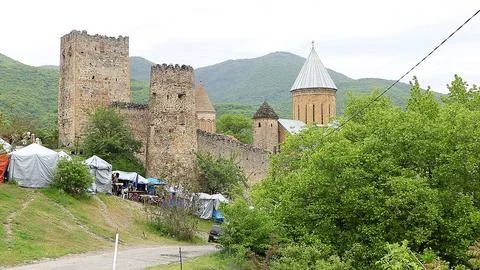 Ananuri Fortress complex with ancient stone towers and church dome in Georgia Photos