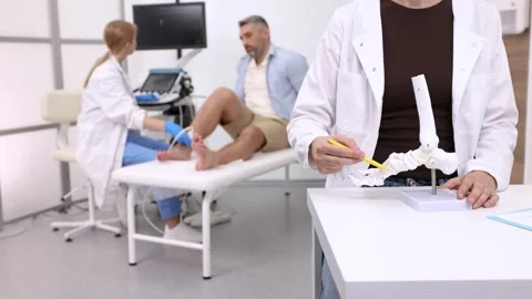 Anatomical model of foot bones on background of process of diagnostics of inj Stock Footage 321001641