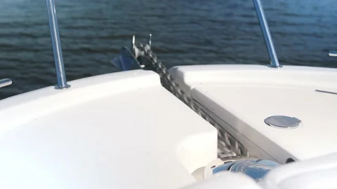 Anchor chain with red mark goes down on contemporary yacht Stock Footage 138728112