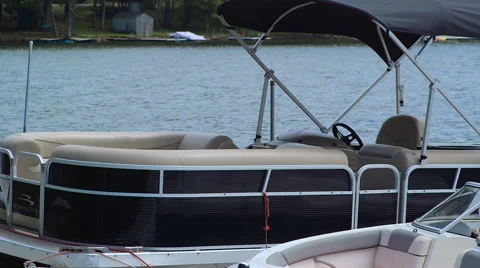 Anchored Boat Near Dock Bobbing on Lake During Cloudy Summer Day Stock Footage