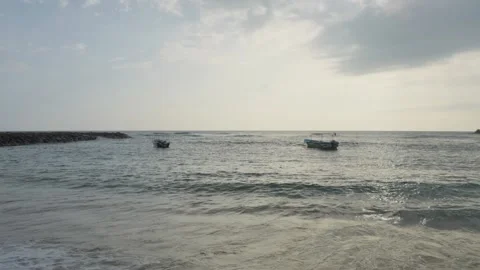 Anchored Boats Beyond Rolling Waves Under Cloudy Sky in Mirissa, Sri Lanka Stock Footage 342323149