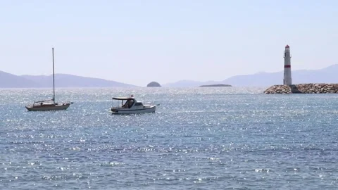 Anchored Boats by the Lighthouse Stock Footage 236663063