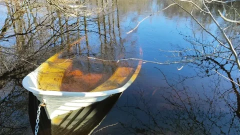 An anchored rowing boat that has partially sunk underwater Stock Footage 171978757