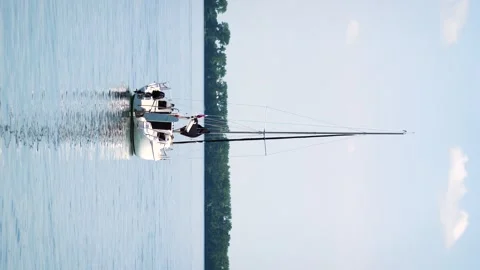 Anchored sailboat on the surface in the harbor Stock Footage 245759405