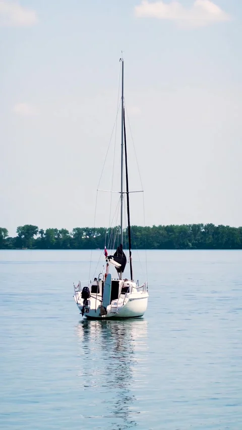 Anchored sailboat on the surface in the harbor Stock Footage 269434971