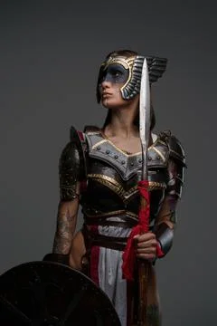 Ancient amazon with shield and spear against gray background Stockfoto's