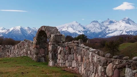 Ancient Arch and Tombs Amidst Majestic Mountain Peaks Stock Footage 304515493