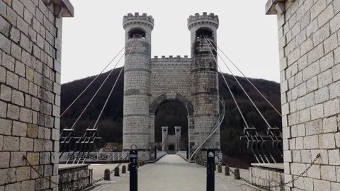Ancient arched  bridge with brick columns and metal cables Stock Footage 82890931