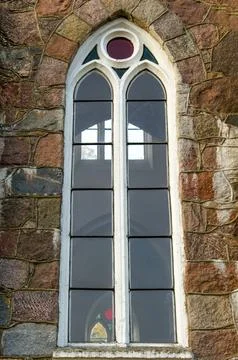 Ancient arched glass windows installed in a stone castle wall Stock Photos