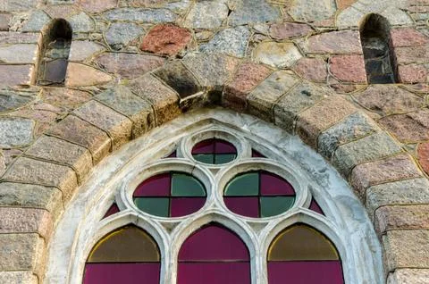 Ancient arched glass windows installed in a stone castle wall Stock Photos