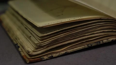 Ancient archival book on table, archivist in gloves flipping fragile pages Stock Footage 306619100