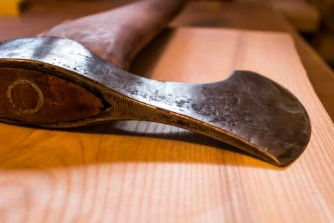 An ancient ax against the background of a tree Stock Photos