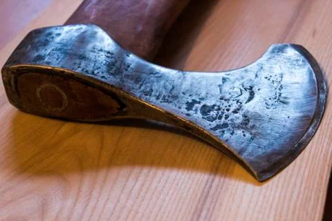 An ancient ax against the background of a tree Stock Photos