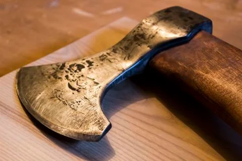 An ancient ax against the background of a tree Stock Photos