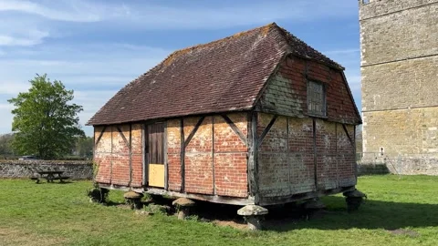 Ancient barn elevated on small stone pillars Stock Footage 308234875