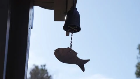 Ancient bell hangs by chain against blue sky Stock Footage 331702120