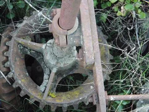Ancient bevel drive engineered cogs to drive a water well mechanism Stock Photos