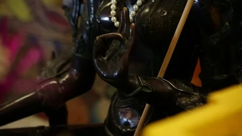 Ancient black buddhist statue - Buddha - pan and tilt Stock Footage 80001172