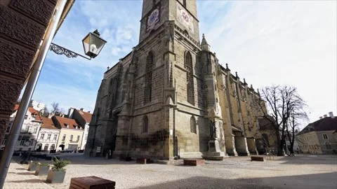 Ancient Black Church tower with clock face stands tall in European city squ.. Stock Footage 339406934