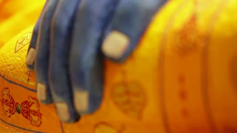 Ancient blue and yellow buddhist statue - detail of the hand of Buddha - focus Stock Footage 80001448