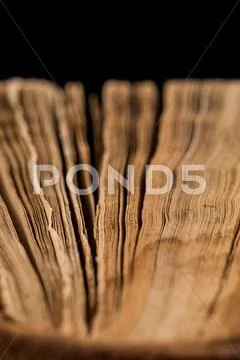 Ancient book shot on black background Stock Photos