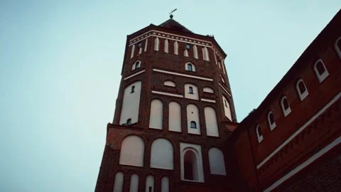 Ancient brick tower with arched windows under a moody sky Stock Footage 301125349